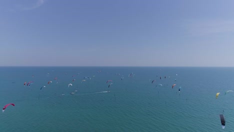 Lots-of-kitesurfers-in-the-mediterranean-sea,-view-by-drone.